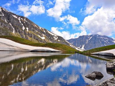 Drakolimni, the alpine Dragon Lake of Mount Tymfi, reflecting the surrounding peaks