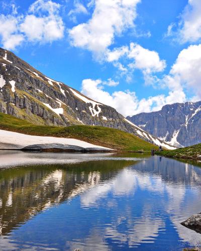 Drakolimni, the alpine Dragon Lake of Mount Tymfi, reflecting the surrounding peaks