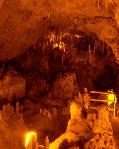 Illuminated stalactites and stalagmites inside Perama Cave near Ioannina