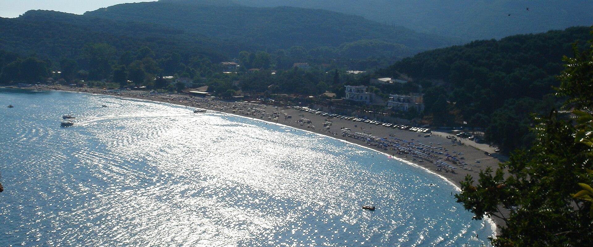 Curving sandy Valtos Beach near Parga with calm blue water