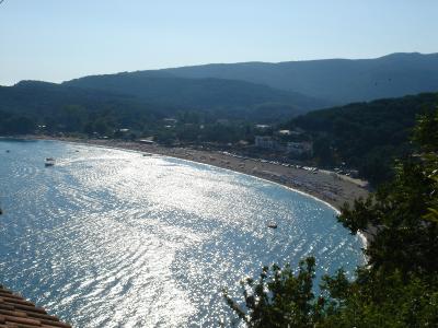 Curving sandy Valtos Beach near Parga with calm blue water