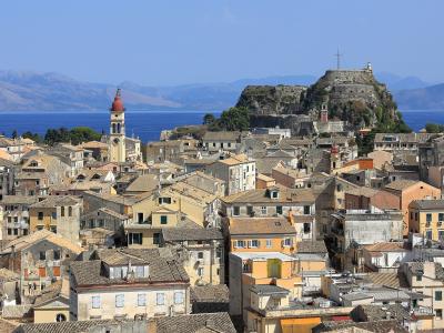The rooftops of Corfu Old Town with the Old Fortress on its headland and the sea beyond.