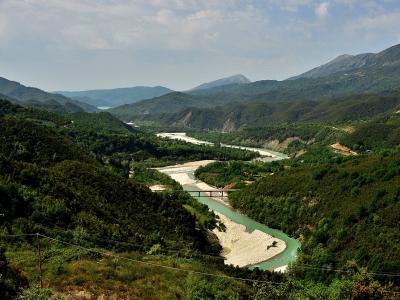 The Arachthos river winding through a green mountain valley in Epirus