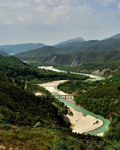 The Arachthos river winding through a green mountain valley in Epirus