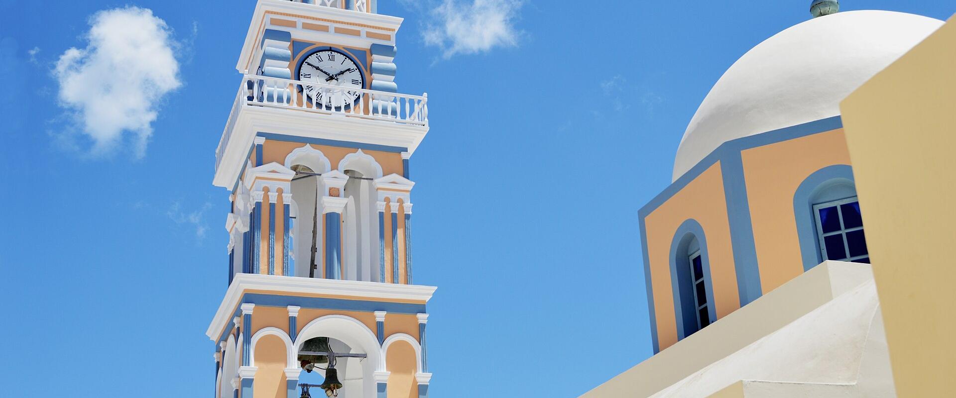 Clock tower and dome of the Catholic Cathedral of St. John the Baptist in Fira, Santorini