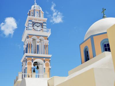 Clock tower and dome of the Catholic Cathedral of St. John the Baptist in Fira, Santorini