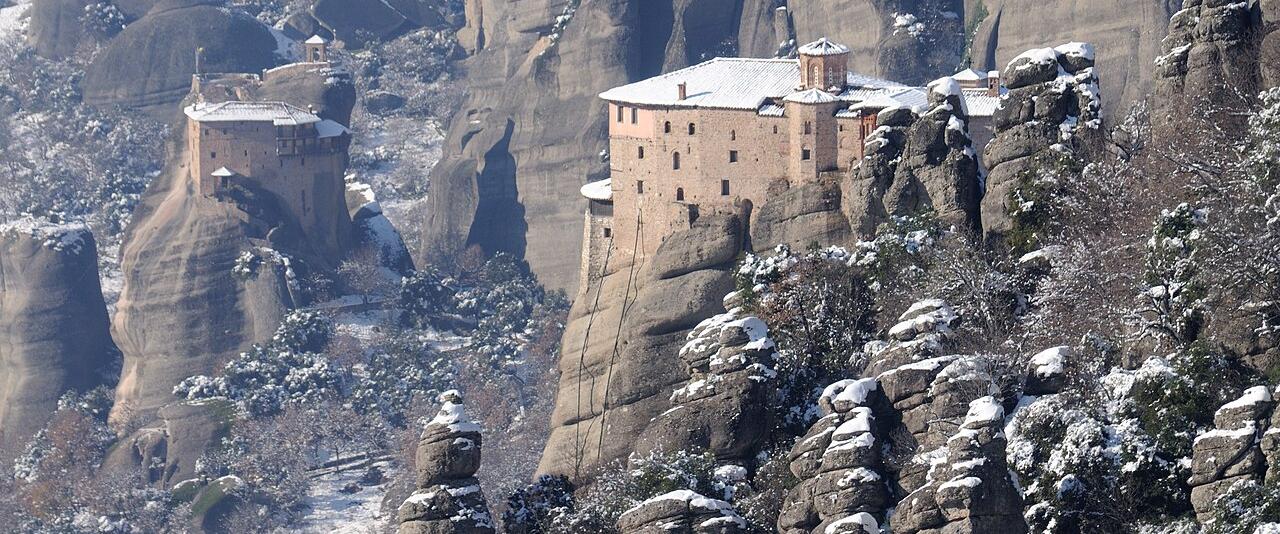 Roussanou Monastery among snow-covered rock pillars at Meteora