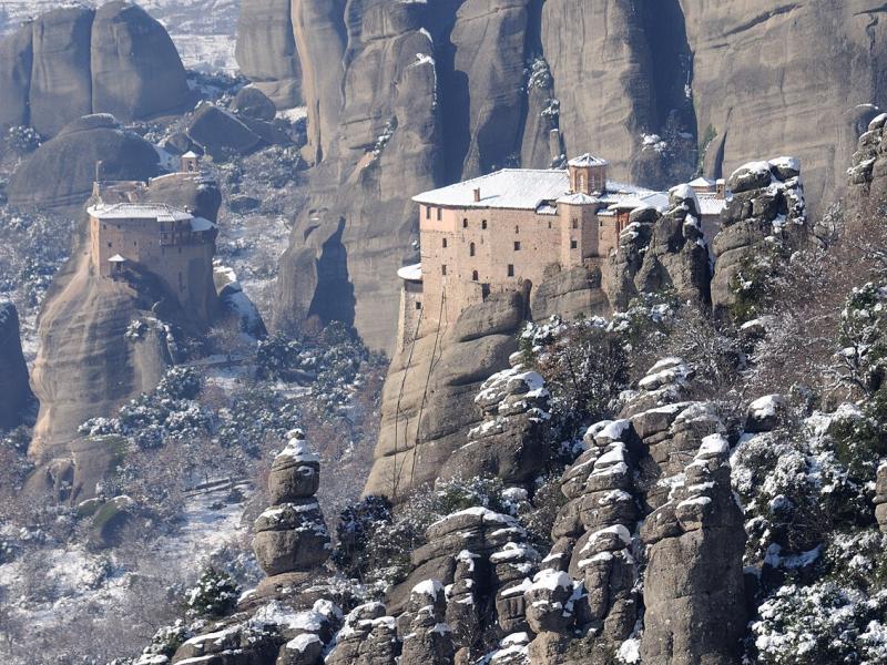 Roussanou Monastery among snow-covered rock pillars at Meteora