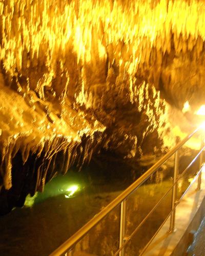 Illuminated stalactites and a railed walkway inside the Dragon's Cave (Spilaia tou Drakou) in Kastoria