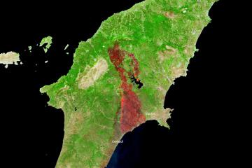 A satellite map image of the Greek island of Rhodes showing burn scars from wildfires, with labels for locations like Gennadi and Lardos.