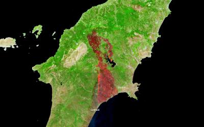 A satellite map image of the Greek island of Rhodes showing burn scars from wildfires, with labels for locations like Gennadi and Lardos.