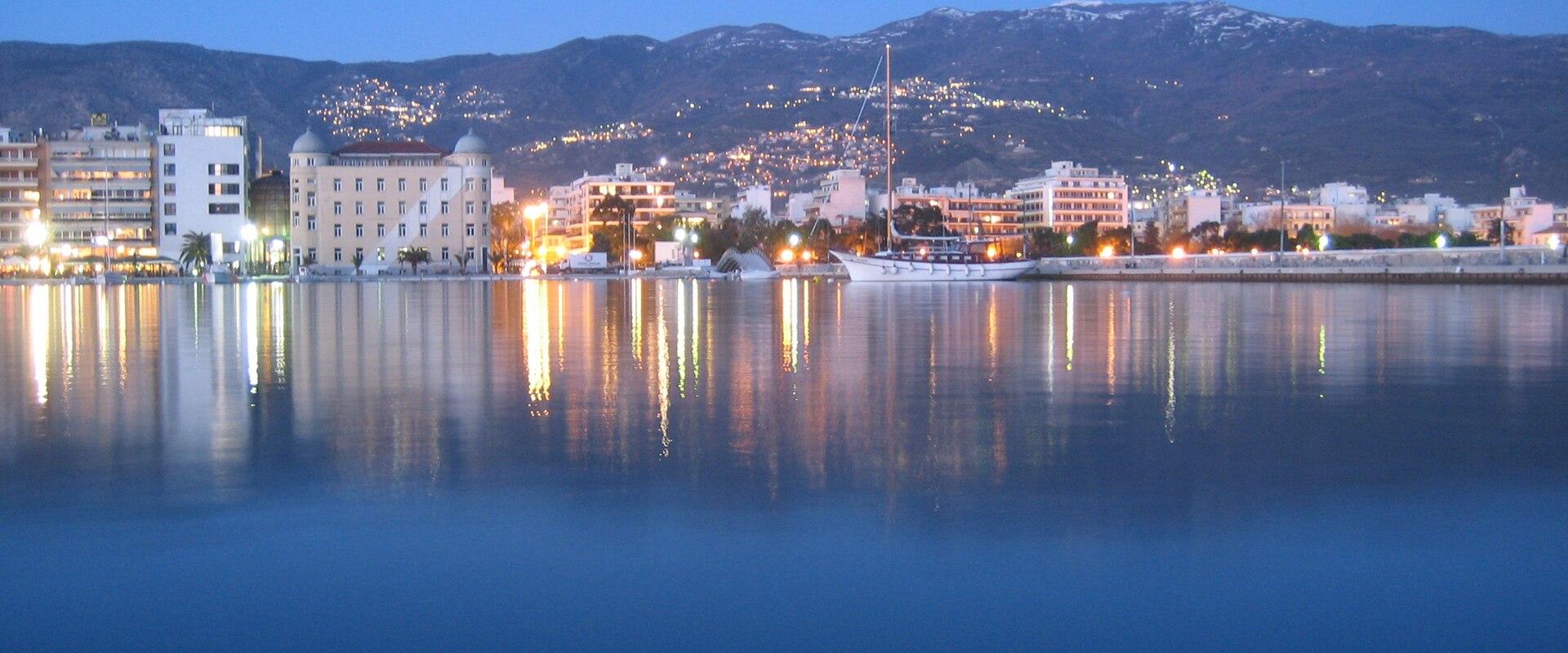 The Volos waterfront and harbour lit up at dusk