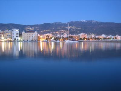 The Volos waterfront and harbour lit up at dusk