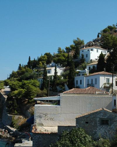 Whitewashed houses of Kamini village above the rocky shore on Hydra